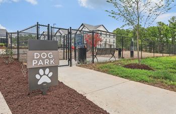 a dog park sign in front of a fence and a dog at Nook Nine, Indianapolis, 46240
